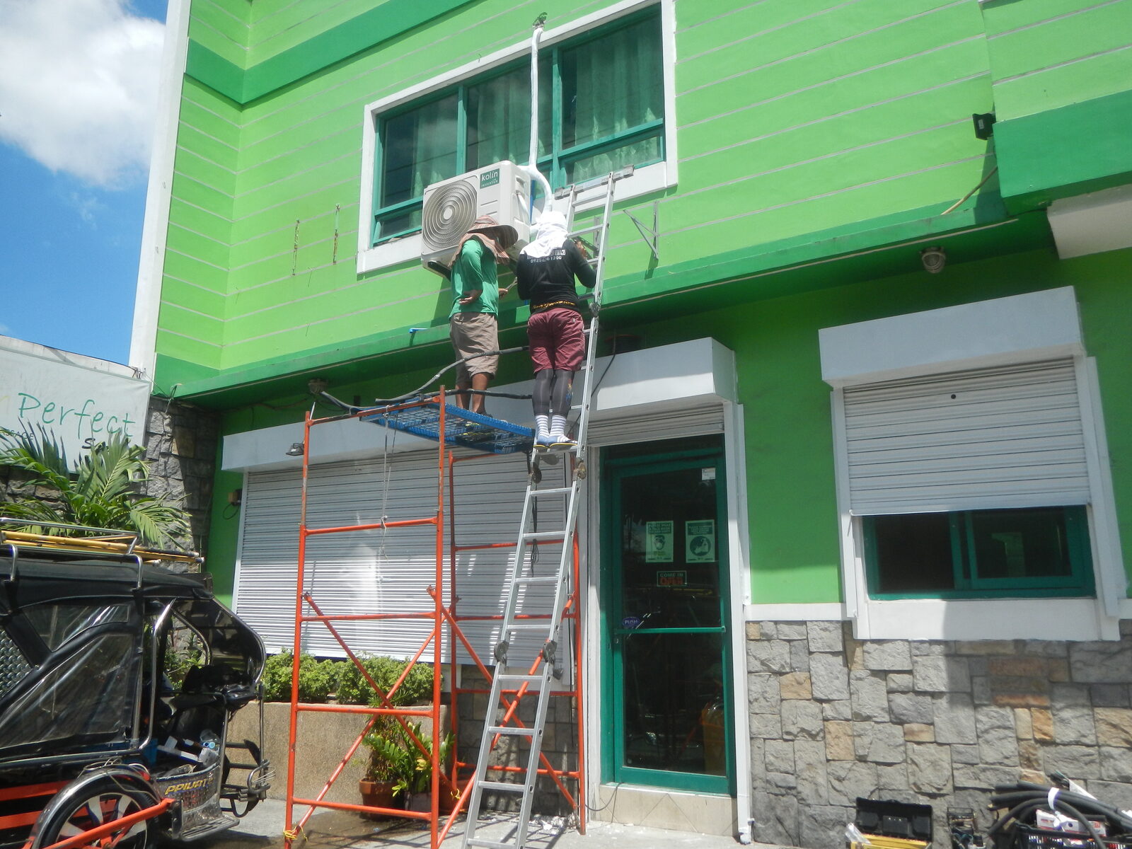 Technicians installing an outdoor air conditioning unit during a professional installation